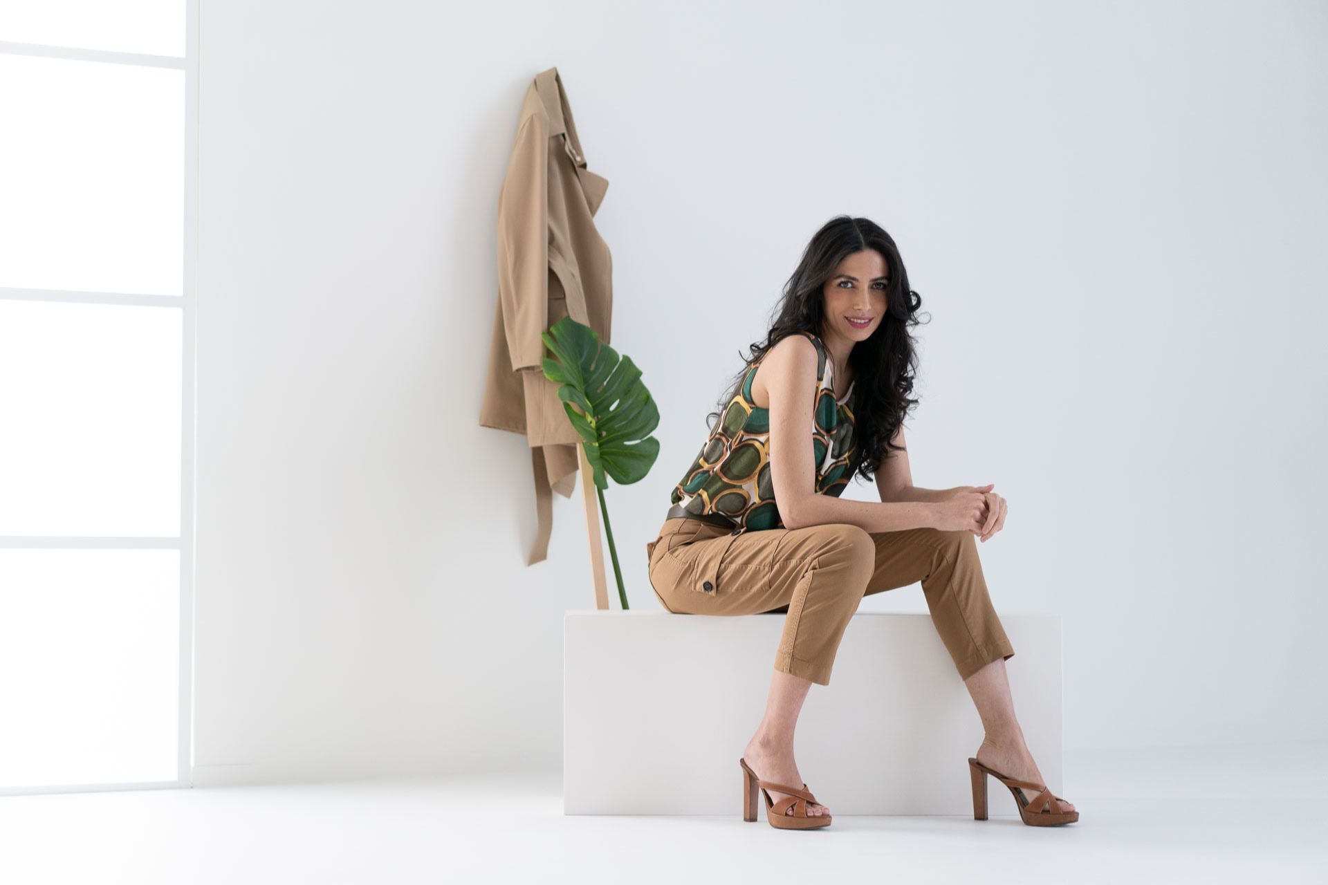 Donna seduta con pantalone cargo e blusa smanicata